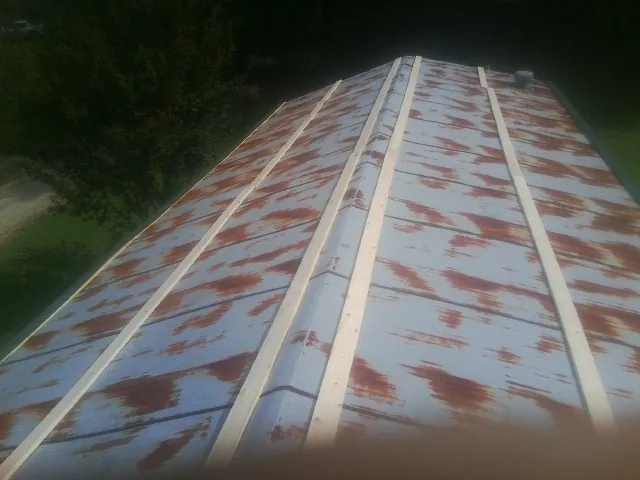Rusted metal roof panels with new wood purlins before replacement — Storm Damage Roof Repair in Aleppo by Roofing Brothers