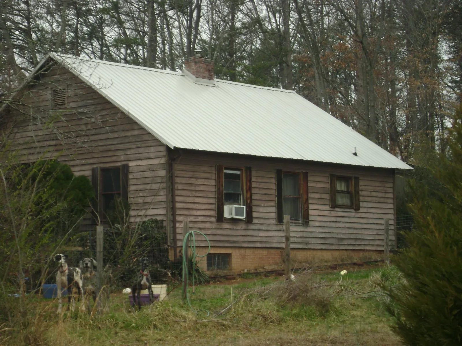 White metal roof on an old wood sided farmhouse, from a Metal Roof Installation job in Aleppo